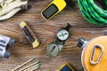 Hiking or travel equipment with boots, compass, binoculars, matches on wooden background. Active lifestyle concept Royalty Free Stock Photo