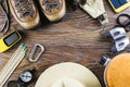 Hiking or travel equipment with boots, compass, binoculars, matches on wooden background. Active lifestyle concept. Royalty Free Stock Photo