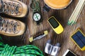 Hiking or travel equipment with boots, compass, binoculars, matches on wooden background. Active lifestyle concept Royalty Free Stock Photo