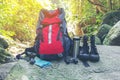 Hiking travel gear on glasses. Items include hiking boots, cup, map,binoculars. Flat lay of outdoor travel equipment items for Royalty Free Stock Photo