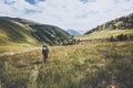 Hiking vacations at wild nature Traveler Man with backpack in mountains Travel Lifestyle concept adventure summer vacations Royalty Free Stock Photo