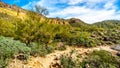 Hiking on the Wind Cave Trail of colorful Usery Mountain surrounded by Large Boulders, Saguaro and other Cacti