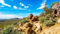 Hiking on the Wind Cave Trail of Usery Mountain surrounded by Large Boulders, Saguaro and other Cacti