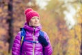 Hiking woman with backpack looking at camera in inspirational au Royalty Free Stock Photo