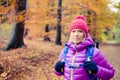 Hiking woman with backpack looking at camera in inspiring autumn Royalty Free Stock Photo