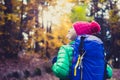 Hiking woman with backpack looking at inspirational autumn golden woods