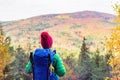 Hiking woman with backpack looking at inspirational autumn mount