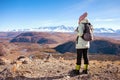 Hiking woman with backpack looking at inspirational autumn mountains