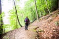 Hiking Woman with backpack. Walking on forest trail on autumn day Royalty Free Stock Photo