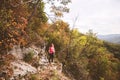 Hiking Woman with backpack. Walking on forest trail on autumn day Royalty Free Stock Photo