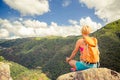 Hiking woman celebrating inspirational mountains landscape