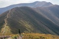 Hiking woman, climber or trail runner in mountains, inspirational landscape. Motivated hiker looking at mountain view Royalty Free Stock Photo