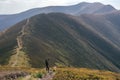 Hiking woman, climber or trail runner in mountains, inspirational landscape. Motivated hiker looking at mountain view Royalty Free Stock Photo