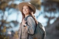 Hiking woman, portrait and smile for adventure, summer and explore forest with backpack, excited and happy. Explorer