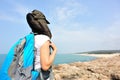 Hiking woman stand seaside rock