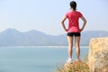 Hiking woman stand seaside rock Royalty Free Stock Photo