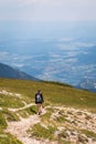 Hiking woman with view from mountain Hochobir to valley Jauntal