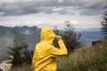 Hiking woman wearing waterproof raincoat in mountain