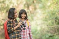 Hiking women use binoculars to travel and have a happy smile. tourist looking through binoculars considers wild birds in the Royalty Free Stock Photo