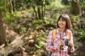 Hiking women use binoculars to travel and have a happy smile. tourist looking through binoculars considers wild birds in the Royalty Free Stock Photo