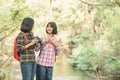 Hiking women use binoculars to travel and have a happy smile. tourist looking through binoculars considers wild birds in the Royalty Free Stock Photo