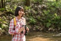 Hiking women use binoculars to travel and have a happy smile. tourist looking through binoculars considers wild birds in the Royalty Free Stock Photo