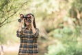 Hiking women use binoculars to travel and have a happy smile. tourist looking through binoculars considers wild birds in the Royalty Free Stock Photo