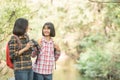 Hiking women use binoculars to travel and have a happy smile. tourist looking through binoculars considers wild birds in the Royalty Free Stock Photo