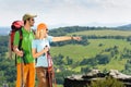 Hiking young couple point at panoramic view