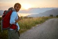 Hiking. Young man with backpacks at evening