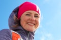 Portrait of young woman winter clothing and standing on mountain and smiling at camera. Woman in warm clothing with