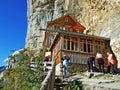 Hiking and Ãâscher cliff restaurant Ascher or Aescher cliff restaurant, Berggasthaus Aescher-Wildkirchli or Mountain inn Aescher Royalty Free Stock Photo