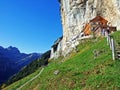 Hiking and Ãâscher cliff restaurant Ascher or Aescher cliff restaurant, Berggasthaus Aescher-Wildkirchli or Mountain inn Aescher Royalty Free Stock Photo