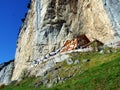 Hiking and Ãâscher cliff restaurant Ascher or Aescher cliff restaurant, Berggasthaus Aescher-Wildkirchli or Mountain inn Aescher Royalty Free Stock Photo