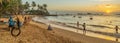 Tourist is walking along Turtle Beach during sunset, Hikkaduwa