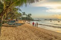 Tourist is walking along Turtle Beach during sunset, Hikkaduwa