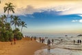 Tourist is walking along Turtle Beach during sunset, Hikkaduwa