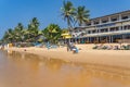 Narigama beach at Hikkaduwa with people on sunbeds and small restaurants in background