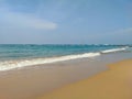 Hikkaduwa, Sri Lanka - March 5, 2022: Beautiful view of the beach in Hikkaduwa against the blue sky. Boats sail along the shore in Royalty Free Stock Photo
