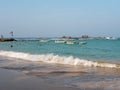 Hikkaduwa, Sri Lanka - March 4, 2022: Beautiful view of the beach in Hikkaduwa. People swim in the Indian Ocean near the boats. Royalty Free Stock Photo