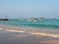 Hikkaduwa, Sri Lanka - March 4, 2022: Beautiful view of the beach in Hikkaduwa. People swim in the Indian Ocean near the boats. Royalty Free Stock Photo