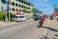 Local seller takes coconuts on bicycle. Street resort on sunny summer day