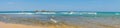 Hikkaduwa, Sri Lanka - March 8, 2022: Panoramic view of the Indian Ocean with azure water at low tide near the coral reef of