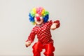 Hilarious five-year-old boy dances in clown costume and wig on white background Royalty Free Stock Photo