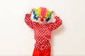 Hilarious five-year-old boy dances in clown costume and wig on white background Royalty Free Stock Photo