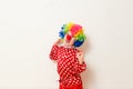 Hilarious five-year-old boy dances in clown costume and wig on white background Royalty Free Stock Photo