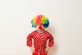 Hilarious five-year-old boy dances in clown costume and wig on white background Royalty Free Stock Photo