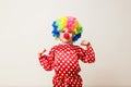 Hilarious five-year-old boy dances in clown costume and wig on white background Royalty Free Stock Photo