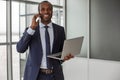 Optimistic businessman is having pleasant communication on mobile phone Royalty Free Stock Photo