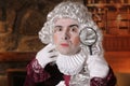 Hilarious old school judge using magnifying glass Royalty Free Stock Photo
